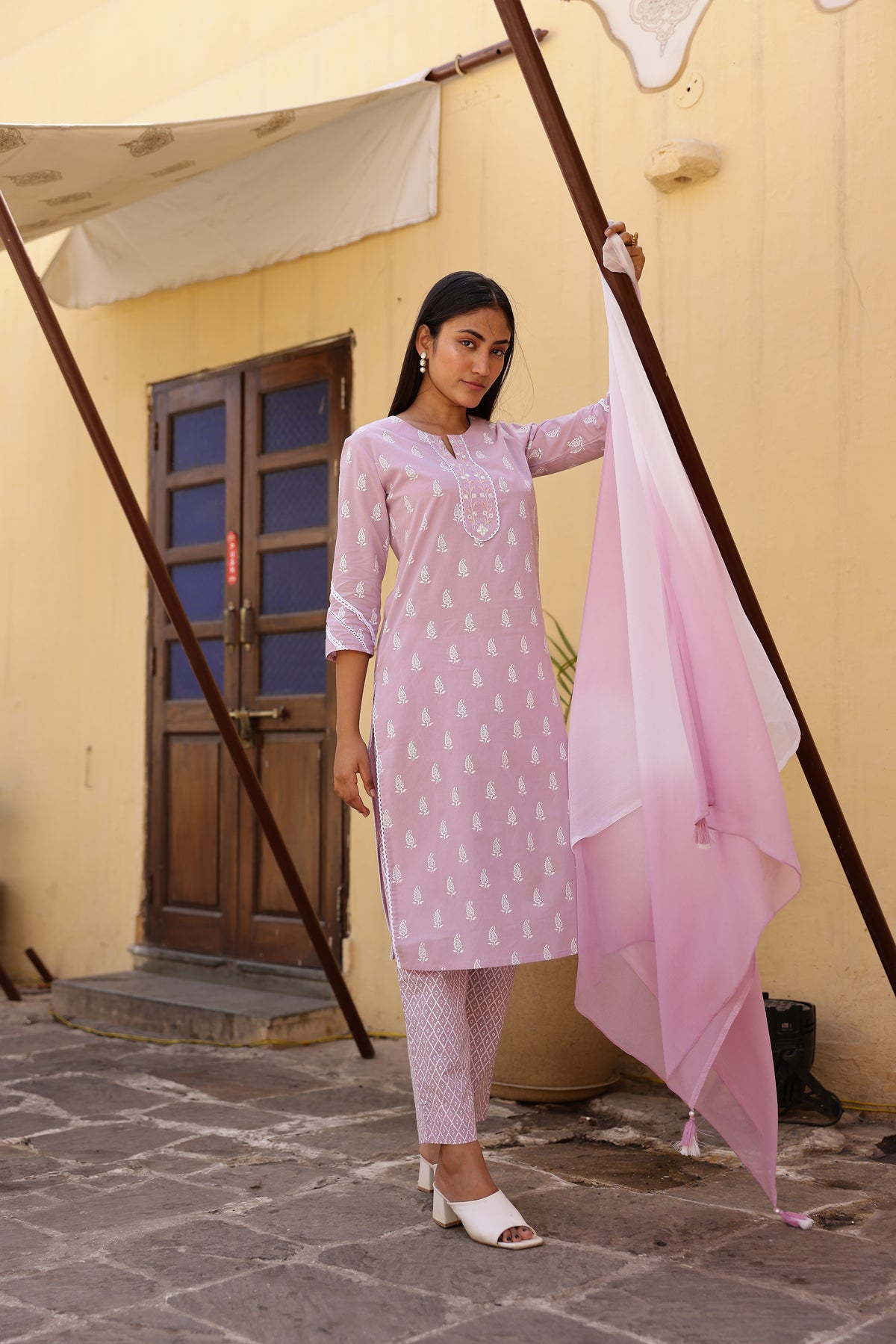 MUL COTTON PRINTED 3PCS. KURTA PANT SET EMBELLISHED WITH EMBROIDERY AND LACE DETAILS.