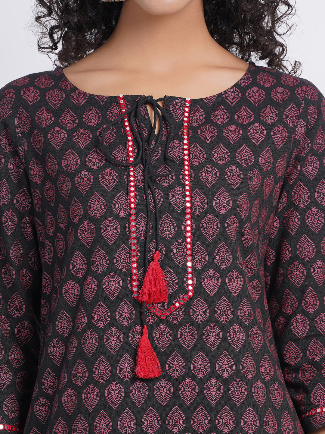 CASUAL WORK WEAR IN OUR CONTRAST PRINTED WITH MIRROR WORK EMBROIDERY STRAIGHT KURTI DETAILED WITH DORI TESSEL.